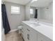 Bathroom with white vanity, brushed nickel hardware and large mirror at 3939 Rudder Way, New Port Richey, FL 34652