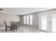 Dining area with glass table, tile flooring, and natural light, adjacent to a door that leads outside at 3939 Rudder Way, New Port Richey, FL 34652