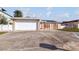 Charming single-story home featuring a two-car garage, stone accents, and a red front door at 3939 Rudder Way, New Port Richey, FL 34652