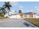 Charming single-story home featuring a two-car garage, stone accents, and solar panels on the roof at 3939 Rudder Way, New Port Richey, FL 34652