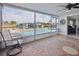 Enclosed patio featuring a pool, a ceiling fan and a view of the canal at 3939 Rudder Way, New Port Richey, FL 34652