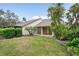 Backyard featuring a lawn and an open-air lanai with sliding glass doors at 4307 Woodmans Chart # 132, Sarasota, FL 34235