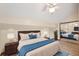 Cozy bedroom boasts a ceiling fan, wood floors, and sliding mirrored closet doors at 4307 Woodmans Chart # 132, Sarasota, FL 34235