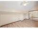 Well-lit bedroom with a ceiling fan, wood-look floors, and mirrored closet doors at 4307 Woodmans Chart # 132, Sarasota, FL 34235