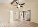 Light-filled bedroom showcasing wood floors, a beam ceiling, and access to additional living space at 4307 Woodmans Chart # 132, Sarasota, FL 34235