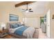 Beautiful bedroom with a vaulted ceiling, beam, ceiling fan, and calming blue accents at 4307 Woodmans Chart # 132, Sarasota, FL 34235