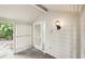 Bright, covered front entrance featuring a white door with a geometric glass design and modern lighting at 4307 Woodmans Chart # 132, Sarasota, FL 34235