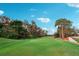 Scenic golf course fairway with mature trees and manicured green, perfect for a day on the links at 4307 Woodmans Chart # 132, Sarasota, FL 34235