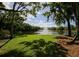 Picturesque pond with a fountain, framed by mature trees and a vibrant green lawn at 4307 Woodmans Chart # 132, Sarasota, FL 34235