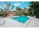 Enjoy the community pool with ample seating, shaded cabana, and lush tropical surroundings at 4307 Woodmans Chart # 132, Sarasota, FL 34235