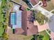 Stunning overhead shot showcasing a backyard pool, landscaped brick patio and walkway, and brown roof at 4309 Deepwater Ln, Tampa, FL 33615