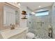 Bathroom featuring vanity with marble countertop and a shower with marble-style tile and glass door at 4309 Deepwater Ln, Tampa, FL 33615