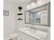 Bright bathroom boasts a large framed mirror and marble countertop vanity at 4309 Deepwater Ln, Tampa, FL 33615