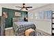 Beautiful bedroom with an accent wall, ceiling fan, and natural light from a window at 4309 Deepwater Ln, Tampa, FL 33615