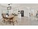 Open dining room featuring a modern chandelier and a view of the bright, updated kitchen at 4309 Deepwater Ln, Tampa, FL 33615