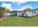 Exterior of home featuring a pool, screened enclosure, fenced yard, and well-maintained lawn at 4309 Deepwater Ln, Tampa, FL 33615