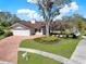 Charming single-story home featuring a manicured lawn and beautiful brick driveway at 4309 Deepwater Ln, Tampa, FL 33615