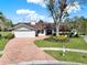 Charming single-story home featuring a manicured lawn and beautiful brick driveway at 4309 Deepwater Ln, Tampa, FL 33615