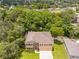 Aerial view of a beautiful two-story home surrounded by lush trees and landscaping at 5147 Elwood Rd, Spring Hill, FL 34608