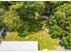 Aerial view of a private backyard surrounded by lush greenery, offering a secluded and peaceful environment at 5147 Elwood Rd, Spring Hill, FL 34608