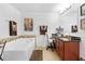 Bright bathroom featuring a soaking tub and a vanity with a chair at 5147 Elwood Rd, Spring Hill, FL 34608