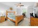 Bright bedroom with a ceiling fan, a window, a bed and an en-suite bathroom at 5147 Elwood Rd, Spring Hill, FL 34608