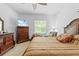 Cozy bedroom features natural light, a ceiling fan, and ample storage space at 5147 Elwood Rd, Spring Hill, FL 34608