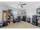 Well-lit bedroom with a ceiling fan, shelving unit, and a large window at 5147 Elwood Rd, Spring Hill, FL 34608