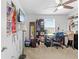 Bright bedroom featuring a ceiling fan, window, desk, and shelving unit at 5147 Elwood Rd, Spring Hill, FL 34608