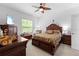 Comfortable bedroom with a ceiling fan and a television near the window at 5147 Elwood Rd, Spring Hill, FL 34608