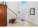 Welcoming foyer with neutral tile, staircase, and bench at 5147 Elwood Rd, Spring Hill, FL 34608