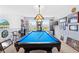 Large upstairs recreation room showcasing a pool table and bright natural light from the window at 5147 Elwood Rd, Spring Hill, FL 34608