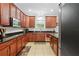 Kitchen with dark wood cabinets, granite countertops and stainless steel appliances at 5147 Elwood Rd, Spring Hill, FL 34608