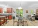 Bright eat-in kitchen area featuring dark countertops and cherry cabinets with a cozy sitting area and natural light at 5147 Elwood Rd, Spring Hill, FL 34608