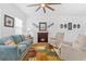 Comfortable living room with a fireplace, plush seating, and a colorful area rug at 5147 Elwood Rd, Spring Hill, FL 34608