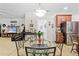 Bright living room featuring modern décor, a glass-top table, tile floors, and open access to the kitchen at 5147 Elwood Rd, Spring Hill, FL 34608