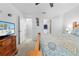 The main bedroom suite with a ceiling fan, dresser, a bed and an en-suite bathroom at 5147 Elwood Rd, Spring Hill, FL 34608