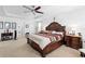 Large main bedroom featuring a ceiling fan, tray ceiling, carpet and a decorative headboard at 5147 Elwood Rd, Spring Hill, FL 34608