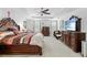 Bright main bedroom featuring a king-size bed, ceiling fan, and ample natural light at 5147 Elwood Rd, Spring Hill, FL 34608