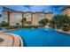 Large outdoor pool with lounge chairs and manicured landscaping at 5200 Brittany S Dr # 902, St Petersburg, FL 33715