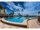 Beautiful outdoor pool with palm trees and tropical scenery at 5200 Brittany S Dr # 902, St Petersburg, FL 33715