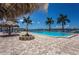 Resort-style pool with tiki umbrellas and lounge chairs overlooking the serene bay waters at 5200 Brittany S Dr # 902, St Petersburg, FL 33715