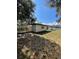 Backyard with privacy fence, grass, and mature trees at 5202 Cumberland Dr, Tampa, FL 33617