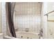 Relaxing soaking tub in a bathroom with a shower and decorative tile at 5202 Cumberland Dr, Tampa, FL 33617