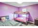 bedroom with a twin bed, a bunk bed, and purple walls at 5202 Cumberland Dr, Tampa, FL 33617