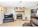 Stone fireplace in a cozy living room with tile floors and an adjacent kitchen at 5202 Cumberland Dr, Tampa, FL 33617