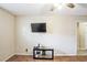 Living room with TV and table, seamlessly flowing into the hallway at 5202 Cumberland Dr, Tampa, FL 33617