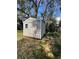 Storage shed with metal siding and single door in the backyard at 5202 Cumberland Dr, Tampa, FL 33617