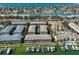 Aerial view of a condo complex with a pool and boat docks in a waterfront community at 521 Pinellas Bayway S # 104, St Petersburg, FL 33715