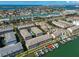 Aerial view of condo complex with boat docks, waterfront access, and lush landscaping at 521 Pinellas Bayway S # 104, St Petersburg, FL 33715